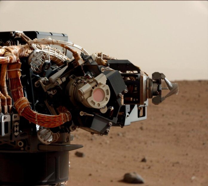 Camera on Curiosity's Arm as Seen by Camera on Mast